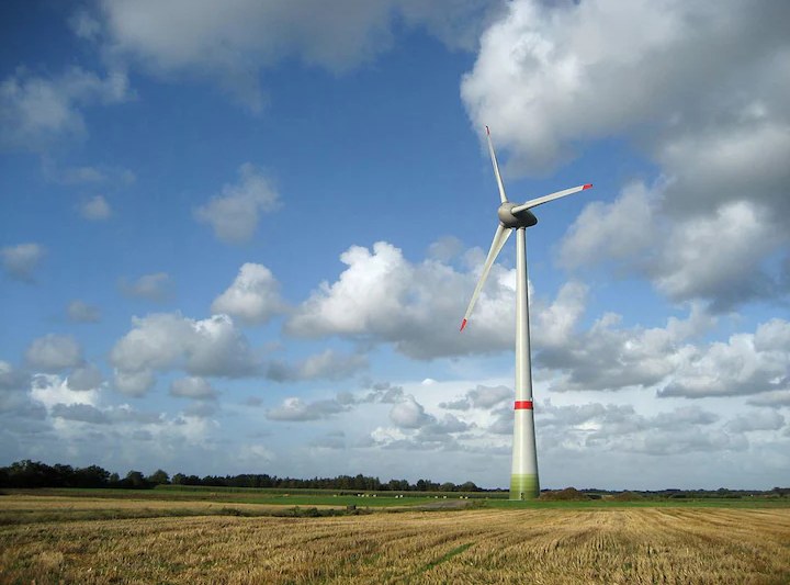 Wind turbine in a field under a Danish summer sky